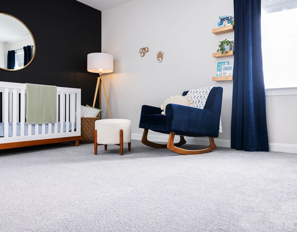 Carpet flooring with blue couch | Yuma Carpets & Tile Inc